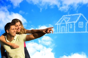 Happy Coupleunder The Blue Sky Dreaming Of A House.